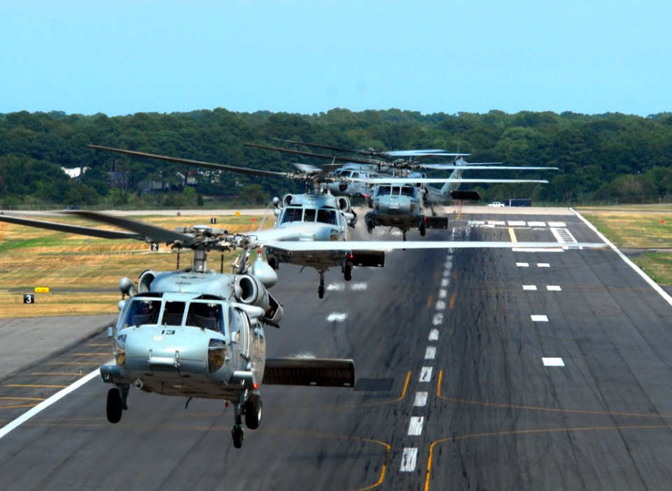 US Navy 070724-N-8907D-429 Five MH-60S Seahawks, from the Sea Knights of Helicopter Sea Combat Squadron (HSC) 22, perform formations over Chambers Field at Naval Station Norfolk