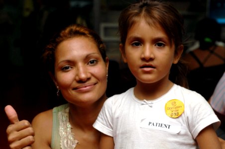 US Navy 070719-N-7088A-005 Lidia Farina and her daughter pose for a photo before being evaluated by Operation Smile medical personnel aboard Military Sealift Command hospital ship USNS Comfort (T-AH 20)