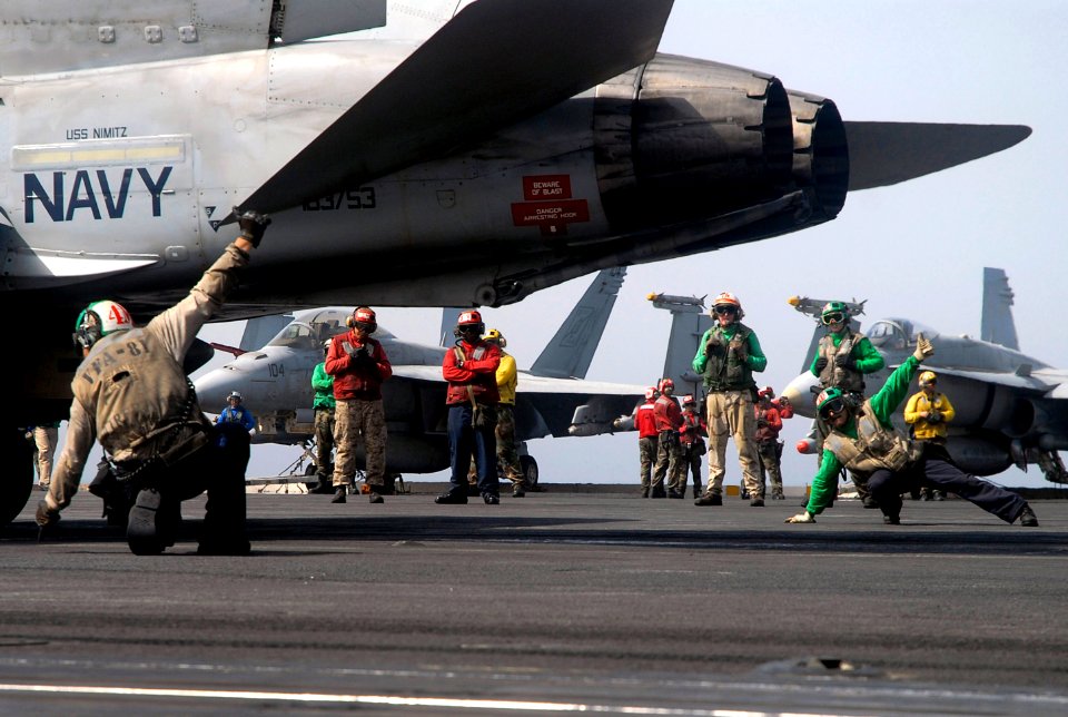 US Navy 070721-N-0890S-054 Sailors signal safe for launch prior to an F-A-18C Hornet, assigned to the Sunliners of Strike Fighter Squadron (VFA) 81, launching off the flight deck of the nuclear-powered aircraft carrier USS Nimi