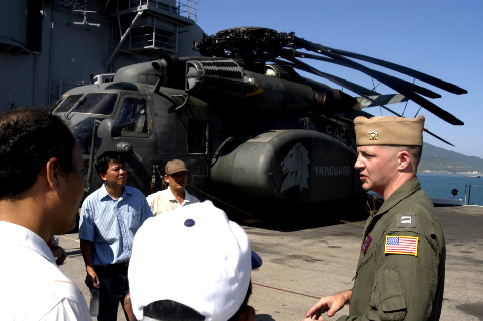 US Navy 070720-N-6410J-026 Lt. Dan Grover speaks with Vietnamese guests about the MH-53E Sea Dragon during a tour of amphibious assault ship USS Peleliu (LHA 5). Peleliu is anchored in Da Nang harbor for a 10-day visit to rende