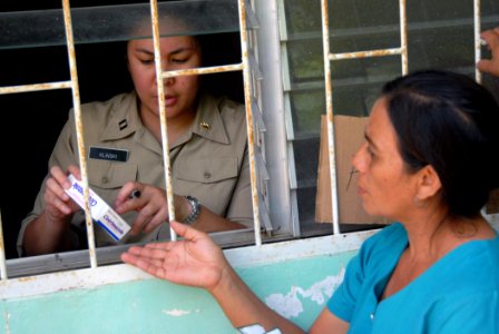US Navy 070720-N-8704K-067 U.S. Navy Lt. Angela Klinski, a pharmacist attached to Military Sealift Command hospital ship USNS Comfort (T-AH 20), provides Marta Ledon with medication from a pharmacy at the 15 de Julio Health Car