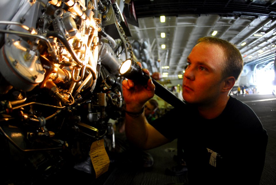 US Navy 070721-N-9760Z-034 Aviation Machinist's Mate 2nd Class Ryan Soderman, assigned to the Black Ravens of Tactical Electronic Warfare Squadron (VAQ) 135, inspects an EA-6B Prowler J-52 engine