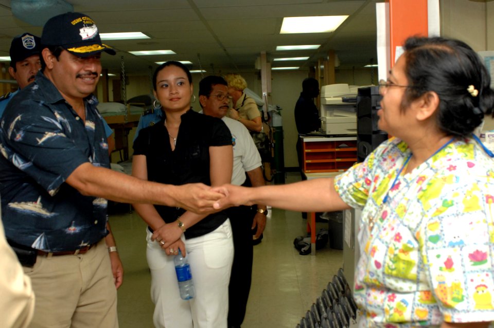 US Navy 070722-N-7088A-007 Ernesto Mendez Zeledon, mayor of Corinto, Nicaragua, greets Esperansa Espinosa, a registered nurse with Operation Smile, in a recovery ward while on a tour of Military Sealift Command hospital ship US