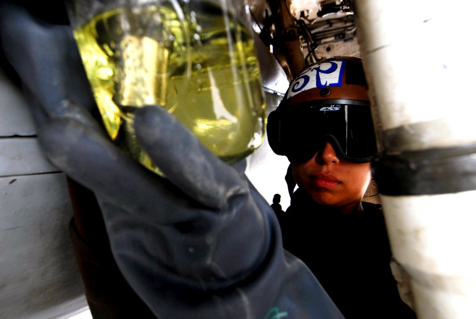 US Navy 070726-N-6326B-045 Airman Yvette Penapuilido, assigned to the Tactical Electronic Warfare Squadron (VAQ) 135, conducts fuel sample tests on an EA-6B Prowler on the flight deck of nuclear-powered aircraft carrier USS Nim