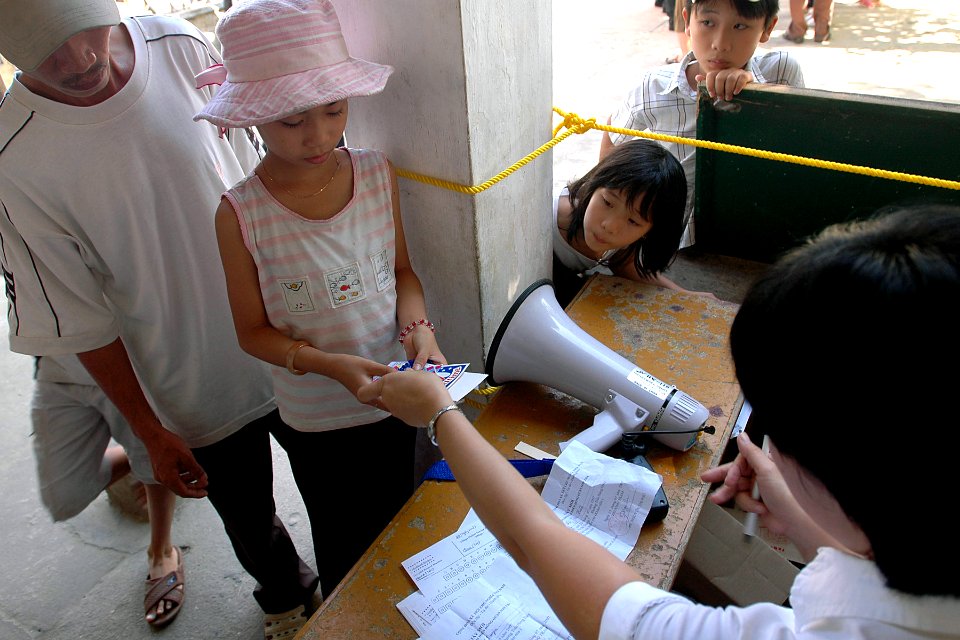 US Navy 070722-N-9421C-032 A volunteer from the Vietnamese Ministry of Health offers dental care products to a local child at a dental civic action program at Nai Hiem Dong Medical Station in support of Pacific Partnership 2007
