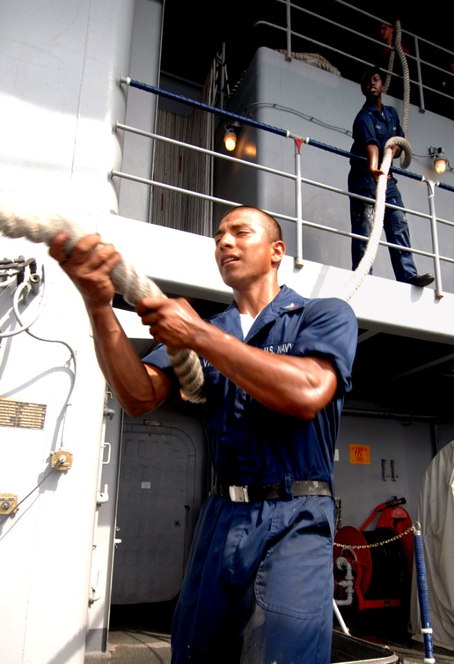US Navy 070724-N-8923M-002 Sailors from deck department bring in a mooring line as Nimitz-class aircraft carrier USS Harry S. Truman (CVN 75) gets underway after a four-day port visit in Fort Lauderdale