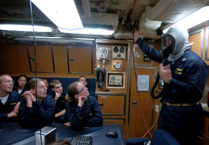 US Navy 070727-N-4163T-139 Midshipmen are instructed on the proper way to don an Emergency Air Breather (EAB) aboard the Los Angeles-class attack submarine USS Helena (SSN 725) photo