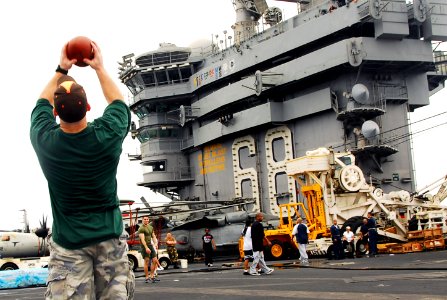 US Navy 070725-N-9760Z-136 Sailors and Marines play football during a steel beach picnic on the flight deck of nuclear-powered aircraft carrier USS Nimitz (CVN 68)