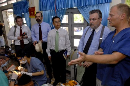 US Navy 070724-N-4954I-131 U.S. Ambassador to Vietnam, the Honorable Michael W. Marine speaks with Lt. Cmdr. Jay Geistkemper, of 3rd Medical Battalion, about dental procedures at the Nai Hiem Dong Medical Station photo