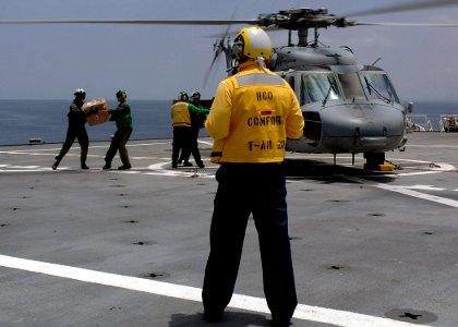 US Navy 070723-N-6278K-052 Helicopter Sea Combat Squadron (HSC) 28 personnel move incoming mail to Military Sealift Command hospital ship USNS Comfort (T-AH 20)