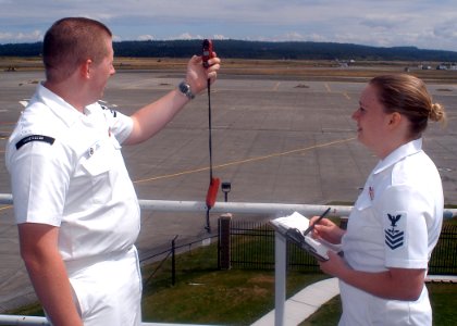 US Navy 070724-N-6247M-001 Aerographers Mate 3rd Class Daniel Miles and Aerographers Mate 1st Class Jessica Martin take weather observations from the rooftop of the operations building at Naval Air Station Whidbey Island
