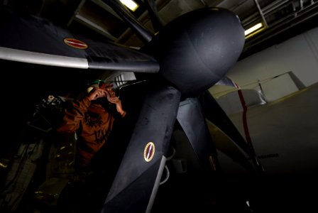 US Navy 070725-N-7981E-185 Aviation Machinist's Mate Airman Recruit Jeremy Smith, assigned to Carrier Airborne Early Warning Squadron (VAW) 116, torques screws on the aft spinner segment of a propeller on an E-2C Hawkeye
