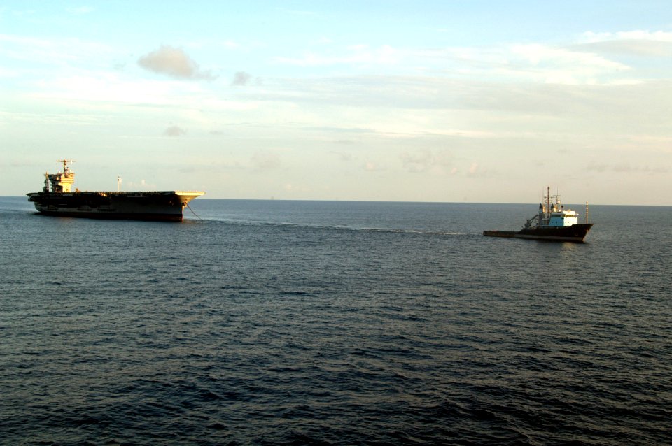 US Navy 070730-N-7955L-087 A tugboat pulls the former aircraft carrier USS John F. Kennedy (CV 67) towards Norfolk, Virginia