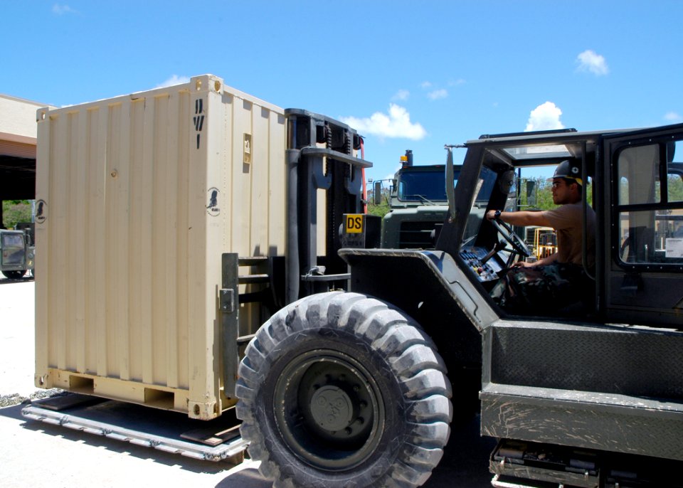 US Navy 070725-F-8678B-046 Builder 1st Class Eric Quinones positions a conex box on pallet during a Fish Hook exercise