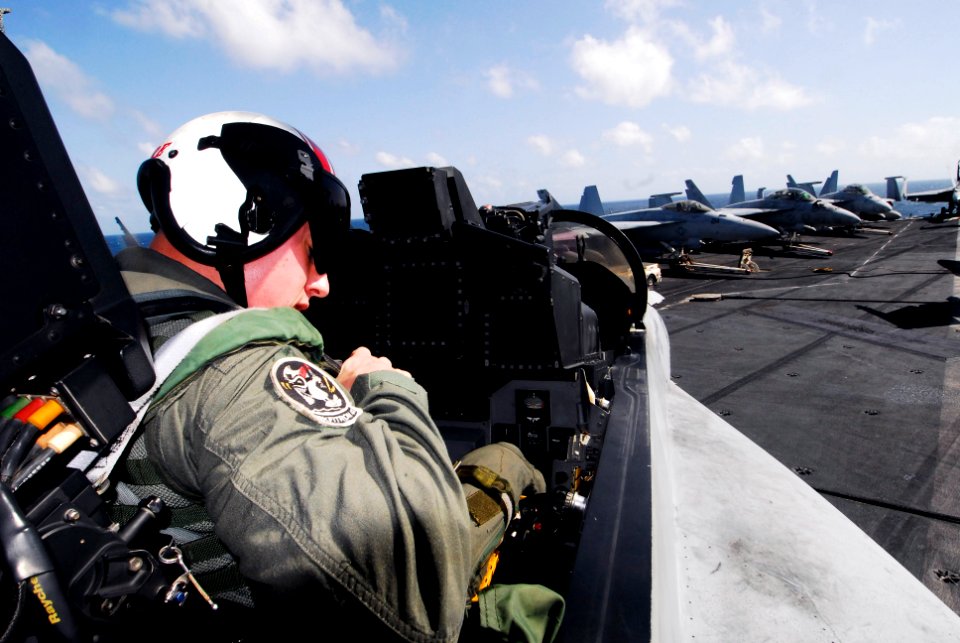 US Navy 070727-N-6326B-057 Lt. j.g. Jeff Creighan, assigned to the Black Aces of Strike Fighter Squadron (VFA) 41, preps an F-A-18F Super Hornet prior to flight operations on the flight deck of the nuclear-powered
