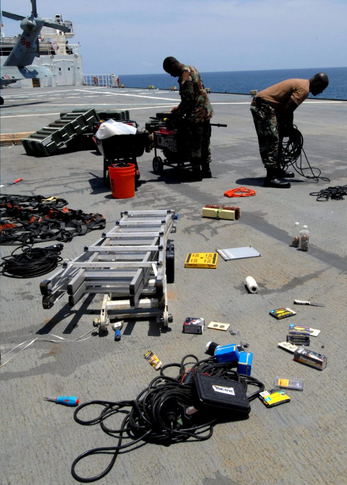 US Navy 070725-N-7088A-053 Members of Construction Battalion Maintenance Unit (CBMU) 202 sort and pack gear on the flight deck of Military Sealift Command hospital ship USNS Comfort (T-AH 20) in preparation for work in El Salva
