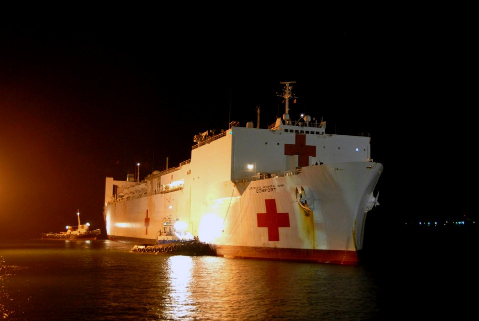 US Navy 070725-N-8704K-235 Tugboats assist Military Sealift Command hospital ship USNS Comfort (T-AH 20) while pulling into port for a scheduled visit