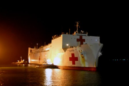 US Navy 070725-N-8704K-235 Tugboats assist Military Sealift Command hospital ship USNS Comfort (T-AH 20) while pulling into port for a scheduled visit
