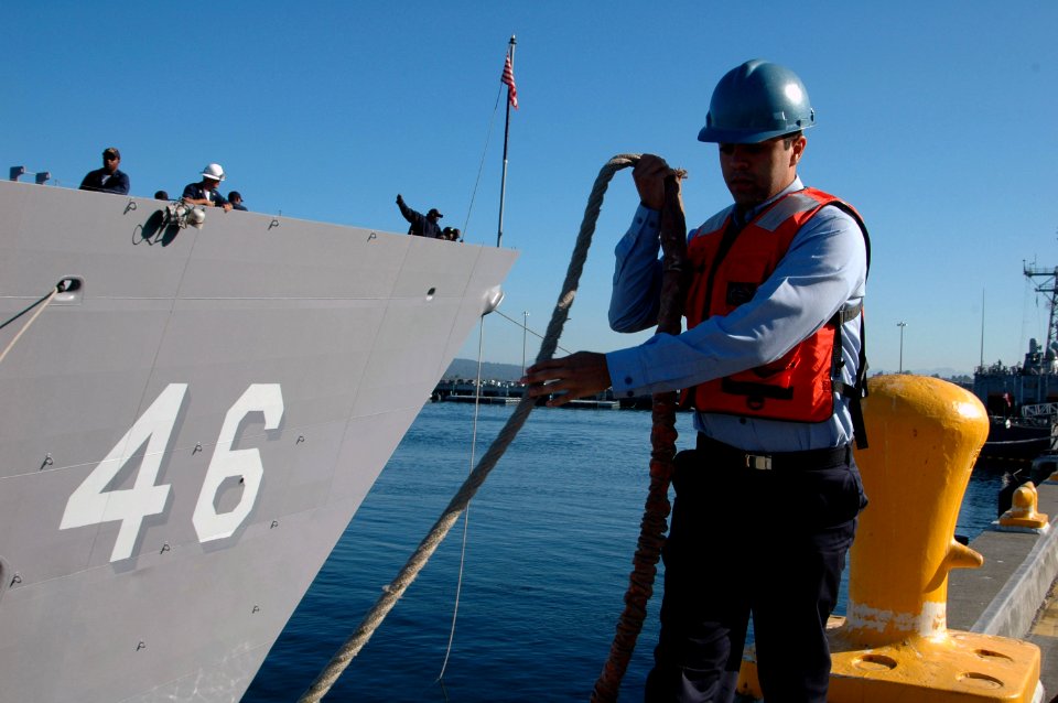 US Navy 070731-N-7431W-001 Seaman Joey Frazzio, assigned to Port Operations at Naval Station (NAVSTA) Everett, assists as line handler in the departure of the guided-missile frigate USS Rentz (FFG 46) in preparation for the shi