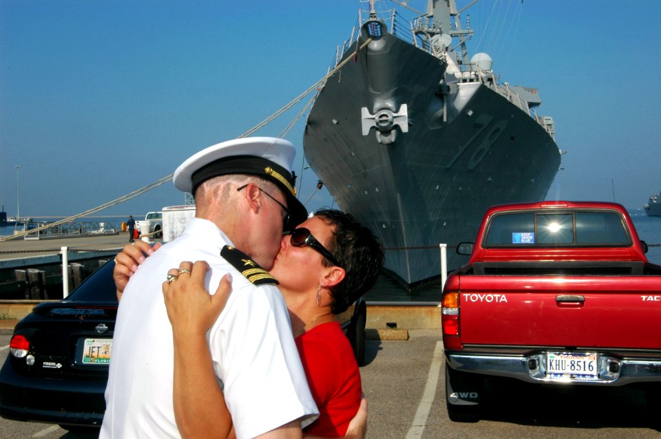 US Navy 070801-N-4014G-044 A Sailor assigned to guided missile destroyer USS Porter (DDG 78) kisses his spouse good-bye prior to boarding Porter to depart for a six-month deployment