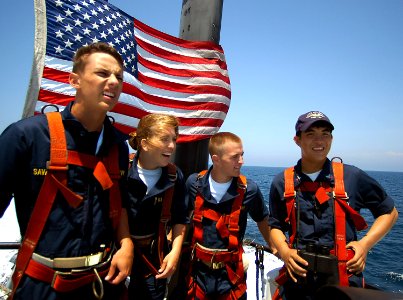 US Navy 070727-N-4163T-062 Midshipmen 3rd Class Anthony Savaglio, Emilie Torielli, and Aaron Smith join Yeoman 3rd Class Jonathan Bong (left) on the bridge of the Los Angeles-class attack submarine USS Helena (SSN 725) photo