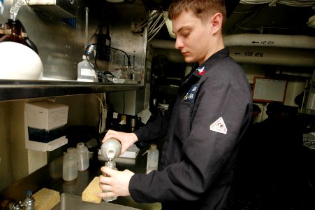US Navy 070726-N-5387K-001 Machinist's Mate 2nd Class Lawrence Payne, from Georgetown, Colo., tests feed water and boiler water samples in the water lab aboard USS Kitty Hawk (CV 63)