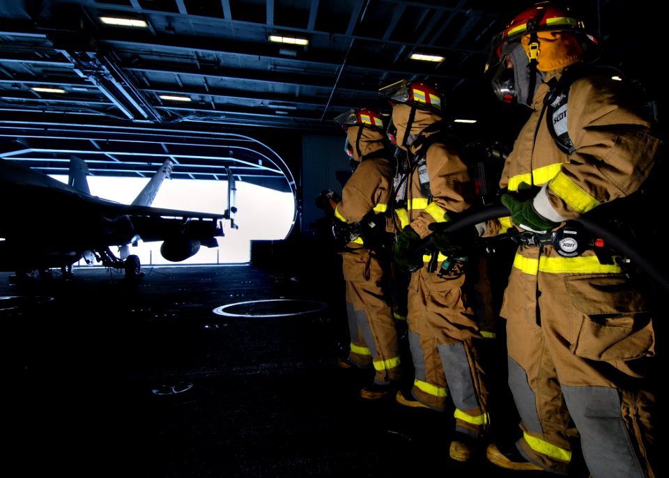 US Navy 070727-N-7981E-083 A hose team assigned to repair locker 1B fights a simulated aircraft fire during a General Quarters (GQ) drill in the hangar bay of Nimitz-class aircraft carrier USS Abraham Lincoln (CVN 72)