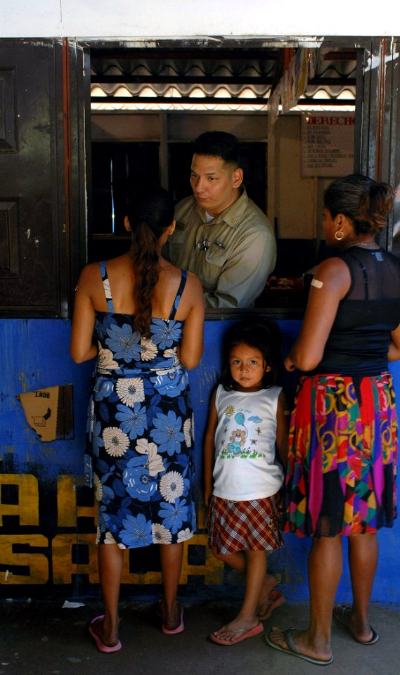 US Navy 070730-N-0194K-248 Chief Hospital Corpsman Joseph Stone, a pharmacist aboard the Military Sealift Command hospital ship USNS Comfort (T-AH 20), provides medicine to Salvadorans, during a humanitarian aid visit
