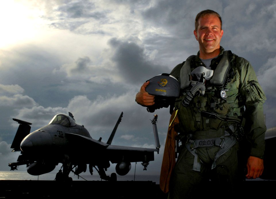 US Navy 070730-N-2984R-001 Lt. Cmdr. Charles Abbot, assigned to the Raging Bulls of Strike Fighter Squadron (VFA) 37, pose on the flight deck aboard the Nimitz-class aircraft carrier USS Harry S. Truman (CVN 75) for a photo for