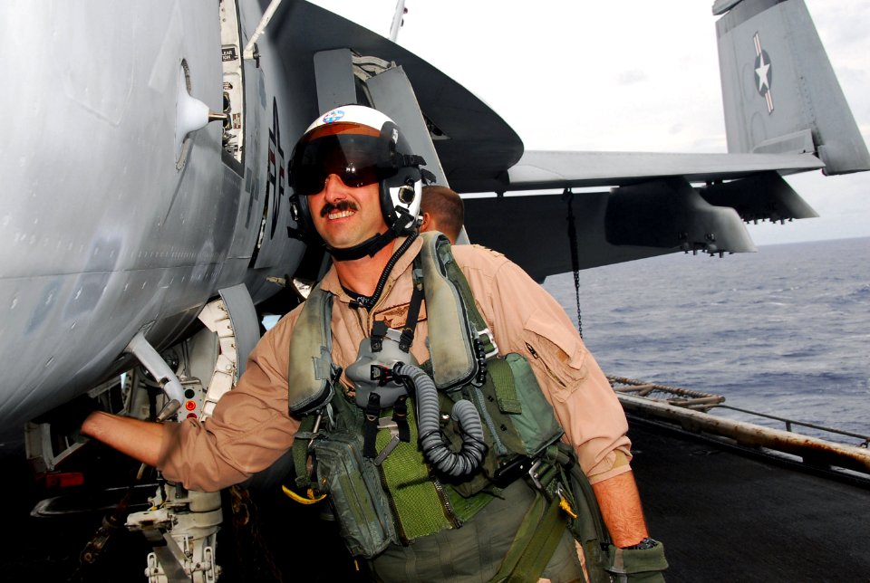 US Navy 070801-N-9760Z-075 Capt. Thomas Downing, deputy commander, Carrier Air Wing (CVW) 11, performs pre-flight checks on the flight deck of the nuclear-powered aircraft carrier USS Nimitz (CVN 68)