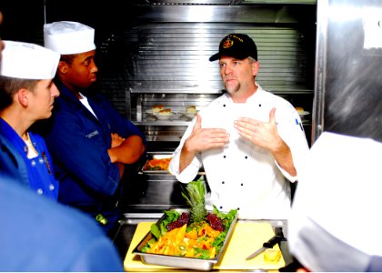 US Navy 070804-N-2638R-003 Civilian Culinary Instructor Jeff Hadley gives Culinary Specialists a demonstration on food presentation aboard Arleigh Burke-class guided-missile destroyer USS John S. McCain (DDG 56)
