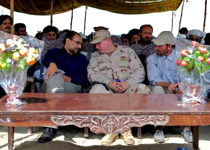 US Navy 070731-N-3385W-048 Commanding Officer of Provincial Reconstruction Team Khost, U.S. Navy Cmdr. David Adams talks with Governor Arsala Jamal prior to the ribbon cutting for the Dadwal Bridge