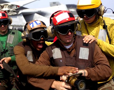 US Navy 070804-N-1598C-107 Crew members fight a simulated aircraft fire during a drill on the flight deck of the nuclear-powered aircraft carrier USS Enterprise (CVN 65)