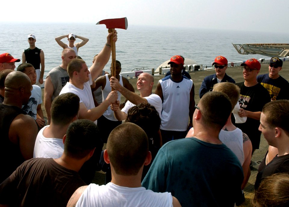 US Navy 070804-N-8909B-014 USS Bonhomme Richard (LHD 6) (BHR) Commanding Officer Capt. Neil R. Parrott (right), of presents the Damage Control (DC) Olympic Fire Axe to Aviation Electronics Technician 1st Class Raul Padilla