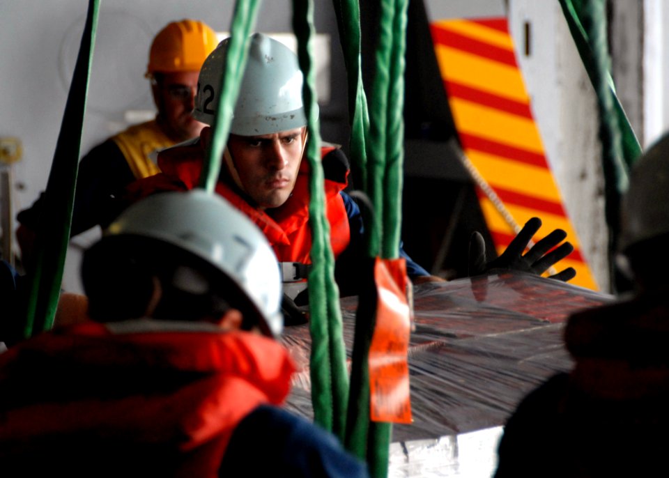 US Navy 070730-N-7981E-104 Riggers guide cargo aboard Nimitz-class aircraft carrier USS Abraham Lincoln (CVN 72) as it is received via connected replenishment from the Modular Cargo Delivery System Ship SS Cape Gibson (T-AK 505