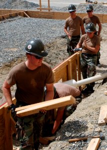 US Navy 070730-A-4352W-010 Petty Officer 3rd Class Daniel Cove, a Seabee assigned to Joint Task Force-Guantanamo, helps build a foundation for the new Leedward Airport fire station
