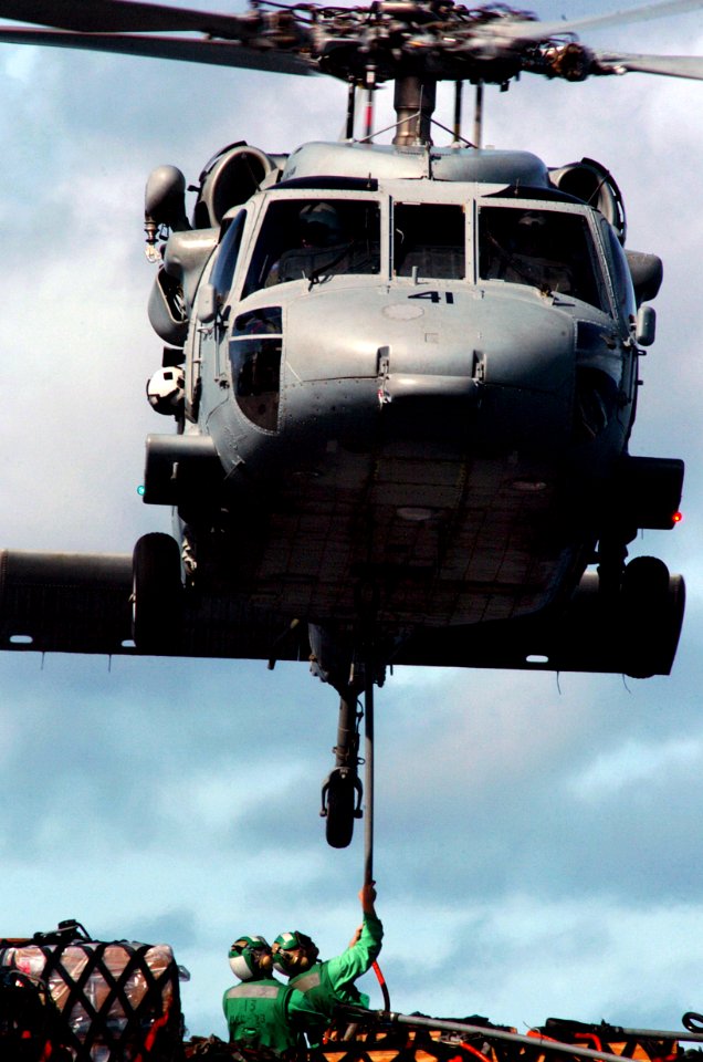 US Navy 070806-N-3038W-282 Sailors aboard the Military Sealift Command fast-combat support ship USNS Bridge (T-AOE 10) attach a cargo pendant to an MH-60S Seahawk