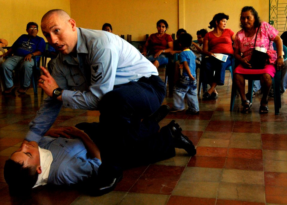 US Navy 070729-N-6278K-272 Hospital Corpsman 2nd Class Samuel Hutcheson, stationed aboard Military Sealift Command hospital ship USNS Comfort (T-AH 20), demonstrates first aid to community health care workers at Casa Comunal
