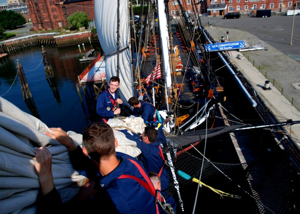 US Navy 070801-N-2385B-002 Working on USS Constitution's bowsprit, Sailors practice setting and furling the flying jib