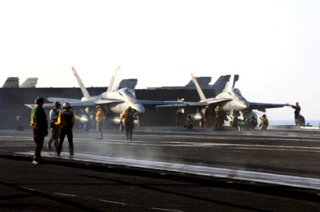 US Navy 070802-N-3729H-045 wo F-A-18C Hornets prepare to launch from catapult three and four on the flight deck of the Nimitz-class aircraft carrier USS John C. Stennis (CVN 74)