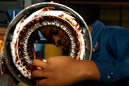 US Navy 070803-N-2970B-005 Electrician's Mate 3d Class Lamelia Brown rewinds and calibrates a ventilation motor at USS Carl Vinson's (CVN 70) Light Industrial Facility (LIFAC) in Newport News, Va
