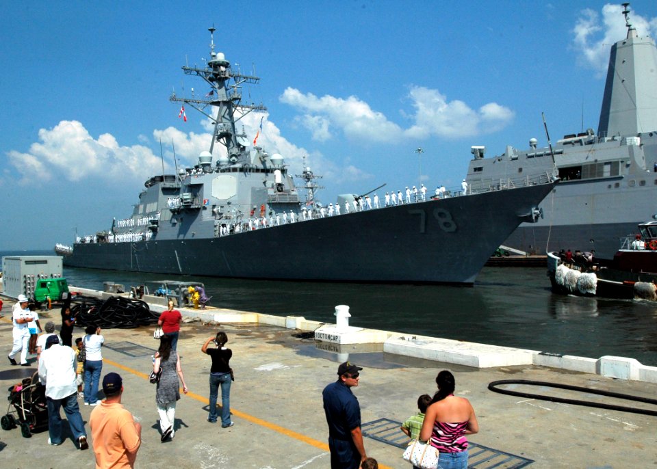 US Navy 070801-N-2456S-240 Family and friends wave goodbye to Sailors assigned to guided missile destroyer USS Porter (DDG 78) as the ship departs Naval Station Norfolk