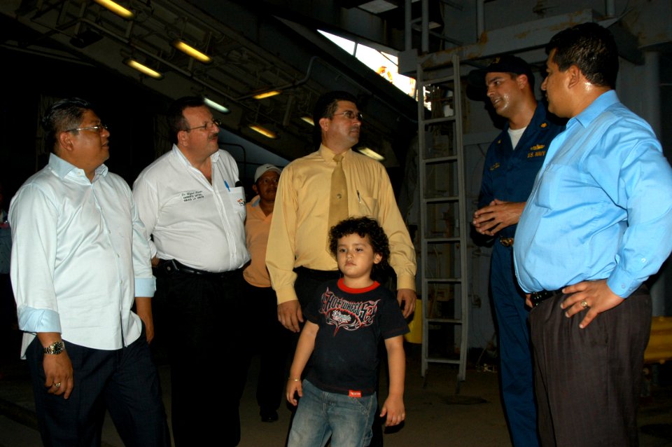 US Navy 070801-N-7029R-062 Lt. Cmdr. Daniel Caldwell, USS Pearl Harbor (LSD 52) executive officer, gives a tour around the ship to government and civil officials from El Salvador in support of Partnership of the Americas (POA)