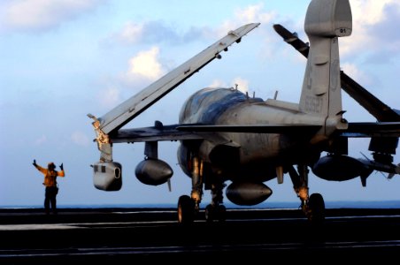 US Navy 070802-N-3729H-158 An aircraft director, from air department's flight deck division, motions an EA-6B Prowler from the