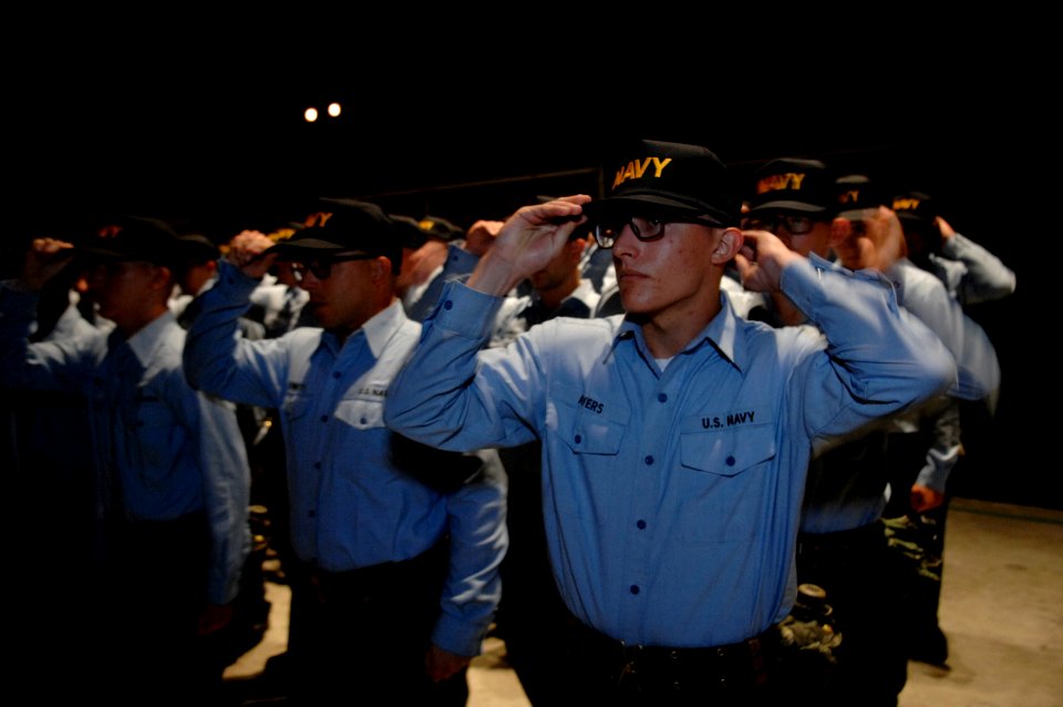 US Navy 070803-N-3642E-192 Sailors don their ball caps for the first time after successfully completing Battle Stations 21 aboard USS Trayer (BST 21)