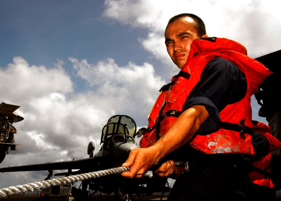 US Navy 070806-N-1513W-005 Seaman Steven Shanks attached to deck department's 3rd division hold a phone and distance line between the Nimitz-class aircraft carrier USS John C. Stennis (CVN 74) and Military Sealift Command fast