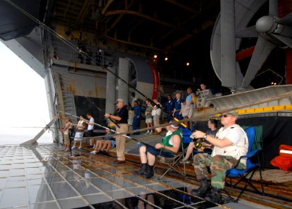 US Navy 070805-N-3211R-033 Sailors aboard the amphibious assault ship USS Bonhomme Richard (LHD 6) (BHR) take part in a fish call off the ship's stern gate