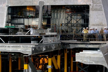 US Navy 070807-N-3642E-042 Secretary of the Navy (SECNAV), the Honorable Dr. Donald C. Winter, is guided onto the aluminum hull of the pre-commissioned ship Independence (LCS 2) during a tour of Austal Shipyards