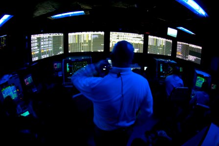 US Navy 070807-N-9864S-003 Senior Chief Air Traffic Controller Ken Kimple, Air Traffic Control Center (CATCC) supervisor, watches as the flight cycle begins aboard USS Kitty Hawk (CV 63)