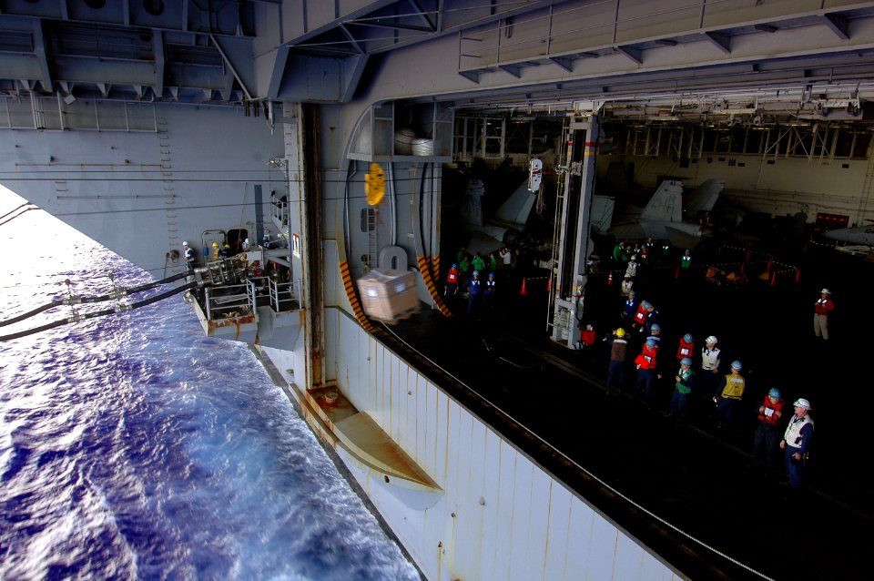 US Navy 070806-N-7883G-014 Sailors aboard the USS Kitty Hawk (CV 63), send cargo to the Military Sealift Command oiler USNS John Ericsson (T-AO 194) during a refueling at sea (RAS)